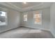 Bright bedroom with carpet and two windows at 4039 Andover Cir, Mcdonough, GA 30252