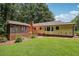 View of the backyard featuring a deck, screened in porch, and ample green space at 9123 Thornton Blvd, Jonesboro, GA 30236