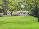 Expansive green lawn behind renovated home with deck at 13130 Providence Rd, Milton, GA 30009