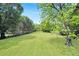 Large grassy backyard with mature trees and wooden fence at 13130 Providence Rd, Milton, GA 30009