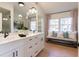 Spa-like bathroom with double vanity, quartz countertops, and a window seat at 13130 Providence Rd, Milton, GA 30009