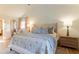 Light and airy primary bedroom with a king-size bed and ensuite bathroom at 13130 Providence Rd, Milton, GA 30009