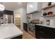 Modern kitchen with stainless steel appliances and dark cabinetry at 13130 Providence Rd, Milton, GA 30009