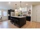 Modern kitchen with dark cabinetry and a large island at 13130 Providence Rd, Milton, GA 30009