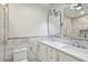 Elegant bathroom with double vanity, marble tile, and glass shower at 952 Lindbergh Ne Dr, Atlanta, GA 30324