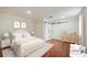 Staged bedroom featuring warm wood floors, barn doors, and a plush queen-size bed at 952 Lindbergh Ne Dr, Atlanta, GA 30324