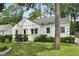 White house with a well-maintained lawn and lush landscaping at 952 Lindbergh Ne Dr, Atlanta, GA 30324