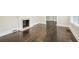 A sunny, empty room with dark, newly refinished wood floors and a classic fireplace at 952 Lindbergh Ne Dr, Atlanta, GA 30324