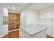 Spacious walk-in closet with white cabinets, granite-topped island, cedar closet, and wood flooring at 952 Lindbergh Ne Dr, Atlanta, GA 30324