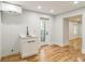 Basement kitchenette with white cabinets, quartz countertops, and hardwood floors at 842 Laurelmont Sw Dr, Atlanta, GA 30311