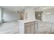 Open concept kitchen island with white quartz countertops and gray cabinets at 229 Ruthe Cv, Locust Grove, GA 30248