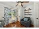 This cozy bedroom features hardwood floors, a comfortable chair, and decorative curtains for a relaxing atmosphere at 2956 Hogan Rd, East Point, GA 30344