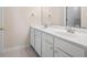 Double vanity bathroom with white cabinets and neutral tile flooring at 3419 Concord Loop, Atlanta, GA 30349