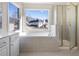 Bathroom with soaking tub, shower, and large window at 3419 Concord Loop, Atlanta, GA 30349