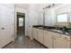 Bathroom featuring double vanity with granite countertops and a view to the bedroom at 108 Laurel Bay Se Dr, Loganville, GA 30052