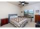 Cozy bedroom with a large window, a bed with a quilt, and a work desk at 108 Laurel Bay Se Dr, Loganville, GA 30052