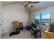 A cluttered bedroom with a ceiling fan and a large window at 108 Laurel Bay Se Dr, Loganville, GA 30052