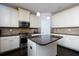 Bright kitchen featuring stainless steel appliances, a granite island, and ample cabinet space at 108 Laurel Bay Se Dr, Loganville, GA 30052