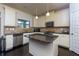 Well-lit kitchen featuring stainless steel appliances, dark wood floors and a granite island at 108 Laurel Bay Se Dr, Loganville, GA 30052