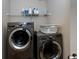 Laundry room complete with washer, dryer and a shelf for added storage at 108 Laurel Bay Se Dr, Loganville, GA 30052