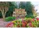 Attractive Laurelmist neighborhood brick sign surrounded by colorful flowerbed and mature trees at 108 Laurel Bay Se Dr, Loganville, GA 30052
