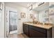 Stylish bathroom with a double sink vanity, granite countertops, and a well-lit mirror at 1363 Midnight Ride Ct, Hampton, GA 30228