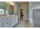 Bathroom with a long vanity, double sinks, and a view into the bedroom at 7214 Gladstone Cir, Stonecrest, GA 30038