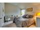 Bedroom features a queen size bed with lamps and carpeted floors at 7214 Gladstone Cir, Stonecrest, GA 30038