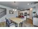 Bright dining area with a classic table, chandelier, and open view to the modern kitchen at 7214 Gladstone Cir, Stonecrest, GA 30038