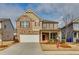 Charming two-story home with brick and siding, a well-manicured lawn, and a two-car garage at 7214 Gladstone Cir, Stonecrest, GA 30038