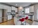 Well-equipped kitchen showcasing stainless steel appliances, granite countertops, a center island and white cabinets at 7214 Gladstone Cir, Stonecrest, GA 30038
