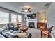 Comfortable living room with fireplace, ceiling fan, and plenty of natural light at 7214 Gladstone Cir, Stonecrest, GA 30038
