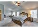 Expansive main bedroom featuring a plush upholstered bed, a sitting area and windows for natural light at 7214 Gladstone Cir, Stonecrest, GA 30038