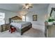 Spacious main bedroom with a luxurious upholstered bed, fan, and ample natural light at 7214 Gladstone Cir, Stonecrest, GA 30038