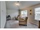 Comfortable sitting area in the main bedroom with armchairs, natural light, and cozy decor at 7214 Gladstone Cir, Stonecrest, GA 30038