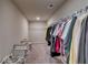 Spacious walk-in closet with ample shelving, hanging space, and seating at 7214 Gladstone Cir, Stonecrest, GA 30038