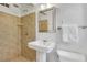 Bathroom featuring tiled shower, pedestal sink, classic design, and ample lighting at 496 Overbrook Nw Dr, Atlanta, GA 30318