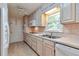 Kitchen with light wood cabinets, stainless steel appliances, and tile floor at 1428 Ridgewood Sw Dr, Lilburn, GA 30047