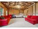 Unfinished basement featuring exposed ceiling and red sofas at 3329 Stetson Overlook Se, Smyrna, GA 30080