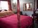 Bedroom with a wooden four-poster bed and red bedding at 6656 Mitchell Sw Ln, Mableton, GA 30126