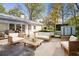 An outdoor patio lounge area with comfortable seating provides relaxation in a backyard setting at 2627 Elsinore St, East Point, GA 30344