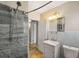 Bathroom features a modern sink and vanity, a tile shower, and a mirror at 2627 Elsinore St, East Point, GA 30344