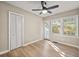 Bedroom with hardwood flooring, ceiling fan, closet and backyard view from the multiple windows at 2627 Elsinore St, East Point, GA 30344