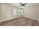Bedroom featuring a ceiling fan and hardwood flooring with a backyard view from the windows at 2627 Elsinore St, East Point, GA 30344