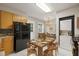 Open concept kitchen and dining area with modern appliances, tile floors, and cozy furniture at 2627 Elsinore St, East Point, GA 30344