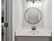 Bathroom features a round mirror, vanity and lighting at 5566 Kingsport Dr, Atlanta, GA 30342