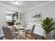 Cozy dining area features a round table with seating for four, adjacent to an open kitchen and a decorative plant at 5566 Kingsport Dr, Atlanta, GA 30342