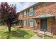 A brick apartment complex features steps leading to the first floor units, as well as green windows and shutters at 5566 Kingsport Dr, Atlanta, GA 30342