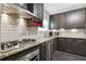 Kitchen features stainless steel appliances, granite countertops, and dark wood cabinets at 5566 Kingsport Dr, Atlanta, GA 30342