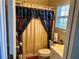 Bright bathroom featuring a shower with colorful curtain and a window for natural light at 5821 Saint Miles Dr, Buford, GA 30518